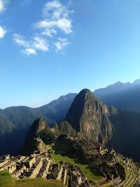 Scenic view of mountains against blue sky