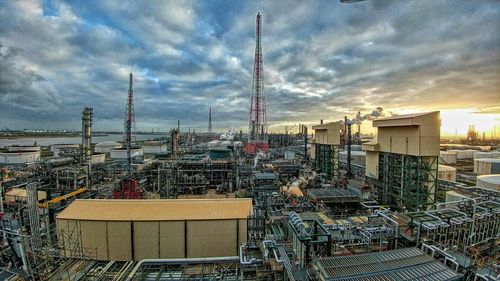 View of cityscape against cloudy sky