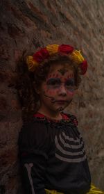 Portrait of girl standing against multi colored wall