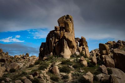 Low angle view of rock formation against sky