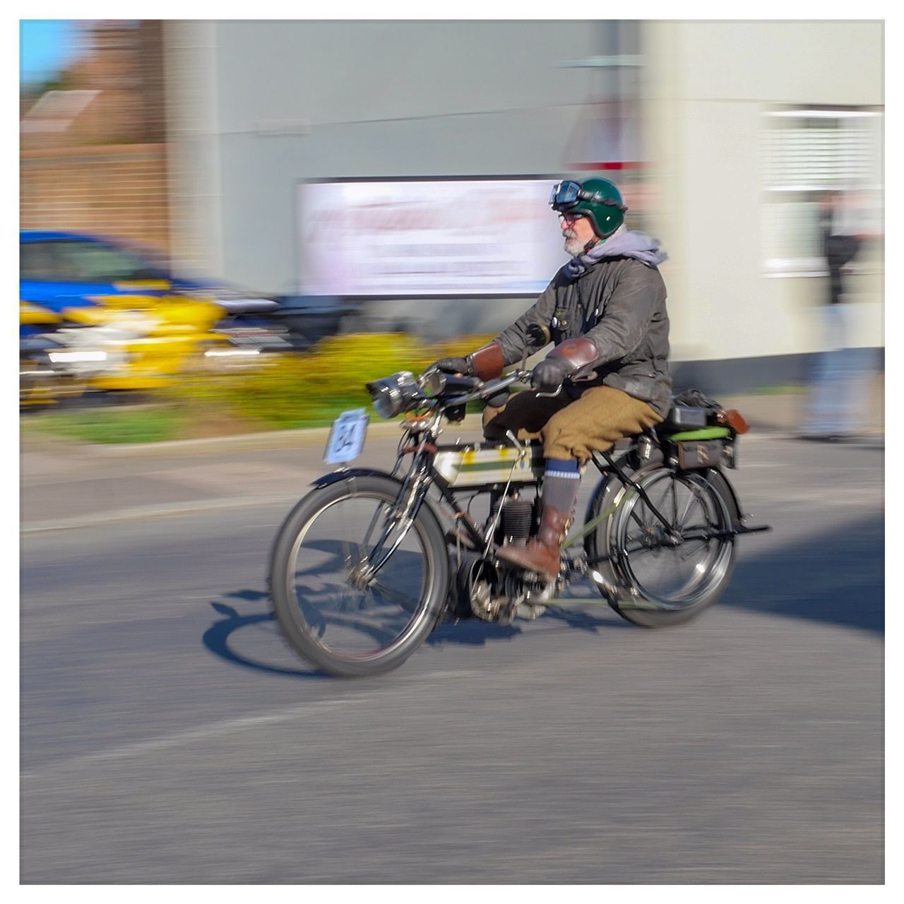 MAN RIDING BICYCLE ON STREET