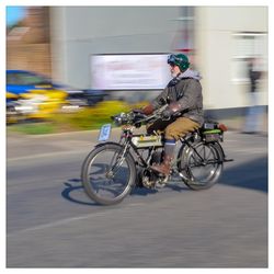 Man riding bicycle on road