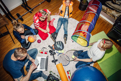 High angle view of family sitting on floor