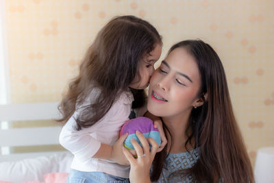 Happy woman with daughter in hair