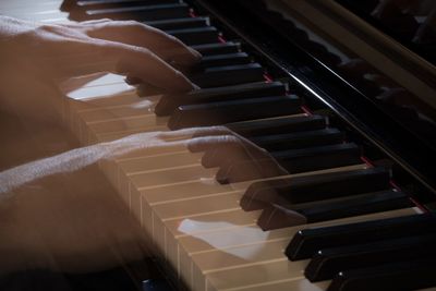 Digital composite image of hands playing piano