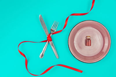 High angle view of decoration on table against blue background