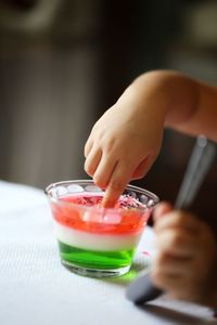 Toddler playing with jelly on a cup