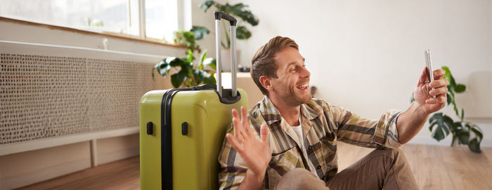 Side view of young man playing guitar