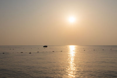 Scenic view of sea against clear sky during sunset