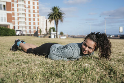 Woman lying down in the grass.