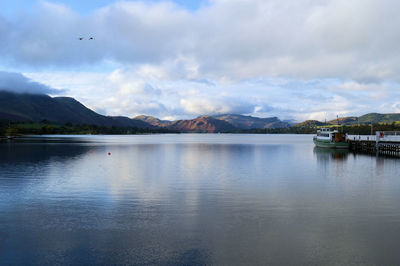 Scenic view of lake against cloudy sky