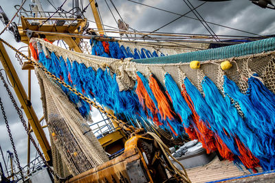 Low angle view of fishing boat moored at harbor