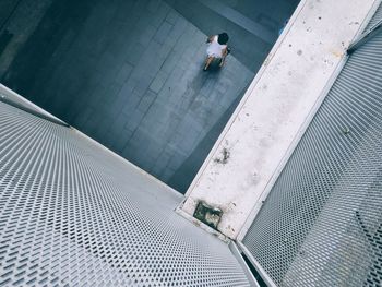 High angle view of man walking by swimming pool