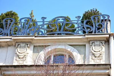 Low angle view of sculpture against clear blue sky