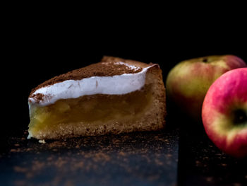 Close-up of apple on table against black background