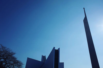 Low angle view of modern building against clear blue sky