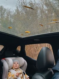 High angle view of a girl sitting in a car