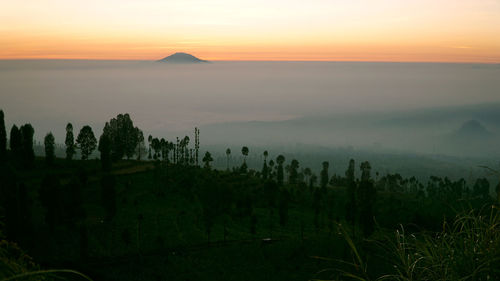 Scenic view of landscape against sky during sunset