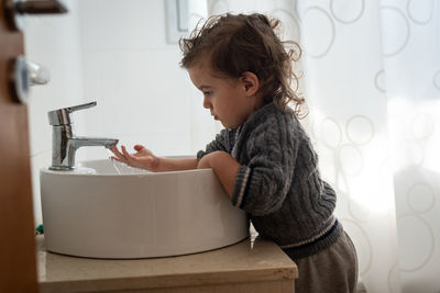 Side view of boy looking at home