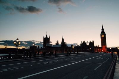 View of clock tower in city at sunset