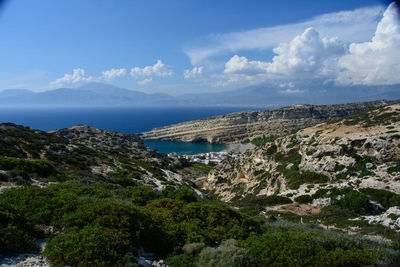 Scenic view of sea and mountains against sky