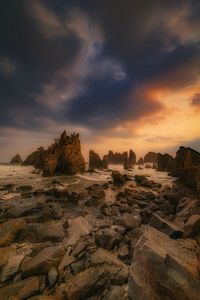 Rock formations on landscape during sunset