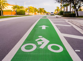 Close-up of bicycle lane sign on road in city