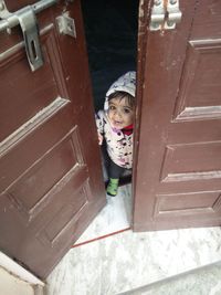 Portrait of cute girl looking at entrance of winter