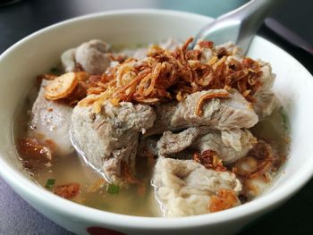 Close-up of fried noodles in meat soup on table