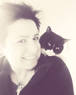 Portrait of smiling woman with cat