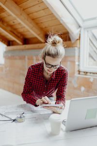 Female architect working at desk in office