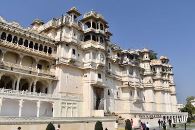 Low angle view of udaipur city palace against sky