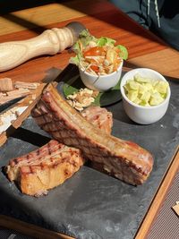 Cropped hand of person preparing food on table