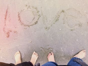 Low section of people standing on beach