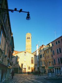 Low angle view of buildings against clear blue sky