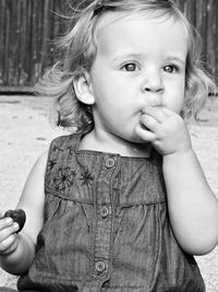 Girl eating chocolate outdoors