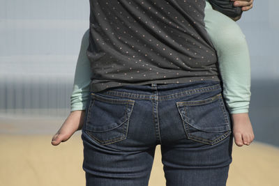 Midsection of man standing against wall