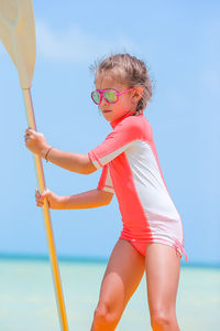 Portrait of young woman standing in sea