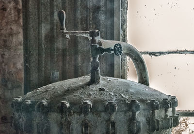 Close-up of rusty metal against wall