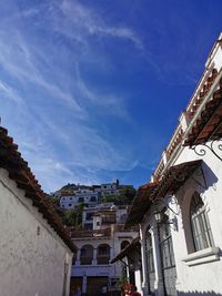 Low angle view of buildings in town against sky