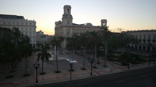 Buildings in city at sunset