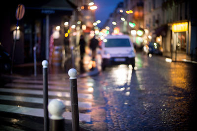 Illuminated city street during rainy season at night