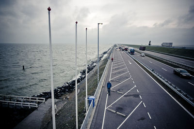 Empty road against cloudy sky