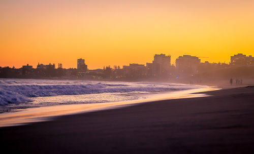 Silhouette of city at sunset