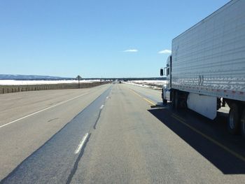 Empty road against blue sky