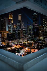 High angle view of illuminated buildings in city at night