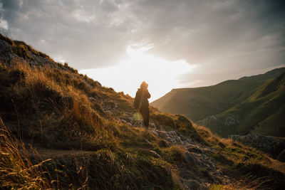 Man standing on mountain against sky