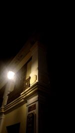 Low angle view of illuminated building against sky at night