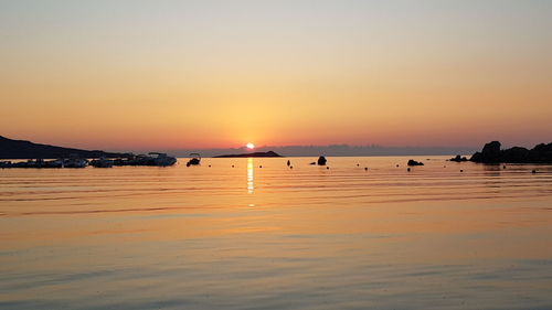 Scenic view of sea against orange sky