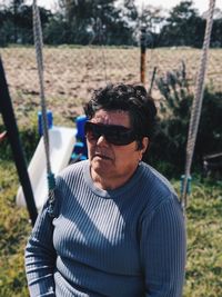 Portrait of man wearing sunglasses on field